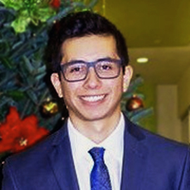 A picture of Juan Contreras in a blue suit