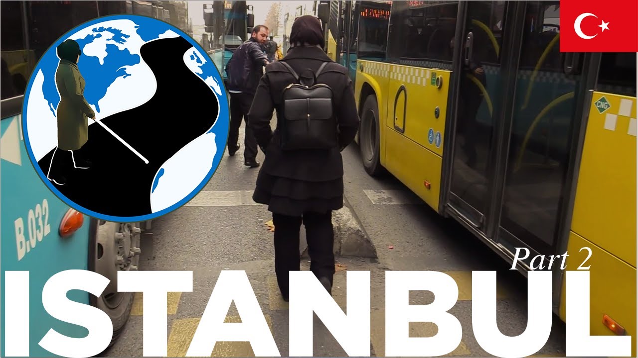 A thumbnail for Say the Name and Just Gesture! - Planes, Trains and Canes Istanbul Episode 3 Part 2. An image of Mona standing in a Turkish bus terminal. Superimposed on the image is the PTC Logo and a flag of Turkey.